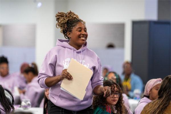 Lariesha Lee, assistant director of the Center for Women & Gender Equity, in a purple sweatshirt